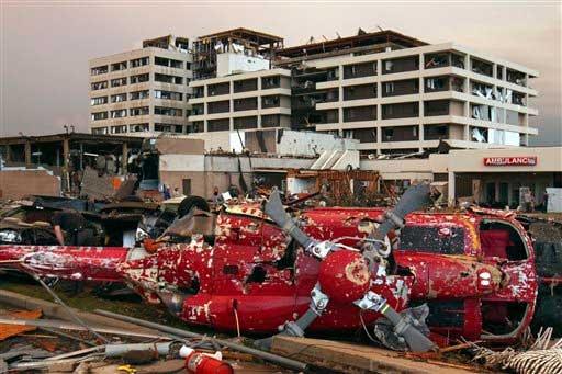 City hospital damaged by tornado, the helicopter thrown from the helipad on its side in the foreground.